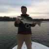 Jason LaButti with a salt pond striper in Ninigret Pond
