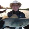 Steve Key with a nice fly rod caught striper in Ninigret Pond. Why is this man smiling?

